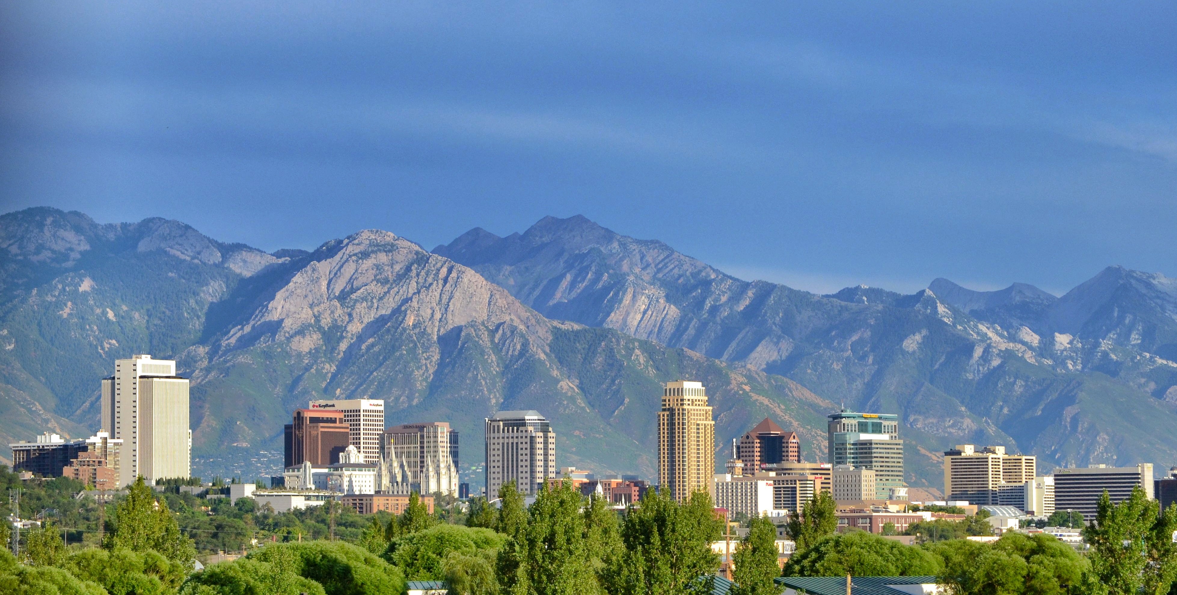 Salt Lake City, often shortened to Salt Lake or SLC, is the capital and most populous city of the U.S. state of Utah. It is the seat of Salt Lake County, the most populous county in the state. With a population of 200,133 in 2020, it is the 117th most populous city in the United States. The city is the core of the Salt Lake City metropolitan area, which had a population of 1,257,936 at the 2020 census. Salt Lake City is further situated within a larger metropolis known as the Salt Lake City–Ogden–Provo Combined Statistical Area, a corridor of contiguous urban and suburban development stretched along a 120-mile (190 km) segment of the Wasatch Front, comprising a population of 2,746,164 (as of 2021 estimates), making it the 22nd largest in the nation. It is also the central core and the larger of only two major urban areas located within the Great Basin (the other being Reno, Nevada).
Salt Lake City was founded on July 24, 1847, by early pioneer settlers led by Brigham Young who were seeking to escape persecution they had experienced while living farther east. The Mormon pioneers, as they would come to be known, entered a semi-arid valley and immediately began planning and building an extensive irrigation network which could feed the population and foster future growth. Salt Lake City's street grid system is based on a standard compass grid plan, with the southeast corner of Temple Square (the area containing the Salt Lake Temple in downtown Salt Lake City) serving as the origin of the Salt Lake meridian. Owing to its proximity to the Great Salt Lake, the city was originally named Great Salt Lake City. In 1868, the word "Great" was dropped from the city's name.Immigration of international members of the Church of Jesus Christ of Latter-day Saints (LDS Church), mining booms, and the construction of the first transcontinental railroad initially brought economic growth, and the city was nicknamed "The Crossroads of the West". It was traversed by the Lincoln Highway, the first transcontinental highway, in 1913. Two major cross-country freeways, I-15 and I-80, now intersect in the city. The city also has a belt route, I-215.
Salt Lake City has developed a strong tourist industry based primarily on skiing, outdoor recreation, and religious tourism. It hosted the 2002 Winter Olympics and is a candidate city for the 2030 Winter Olympics. It is known for its politically liberal culture, which stands in contrast with the rest of the state's highly conservative leanings. It is home to a significant LGBT community and hosts the annual Utah Pride Festival. It is the industrial banking center of the United States. Salt Lake City and the surrounding area are also the location of several institutions of higher education including the state's flagship research school, the University of Utah. Sustained drought in Utah has more recently strained Salt Lake City's water security and caused the Great Salt Lake level to drop to record low levels, and has impacted the local and state economy.